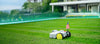 BESTMOW robot lawn mower on a well-maintained lawn with a modern house in the background