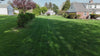 Load video: Aerial view of a robot lawn mower working on the lawn.